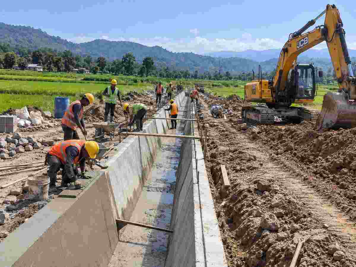 Lined canal construction work in a rural setting