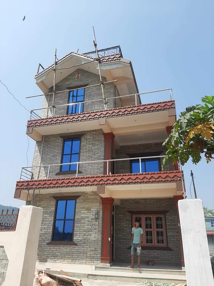 Compact residential building with stone exterior finish