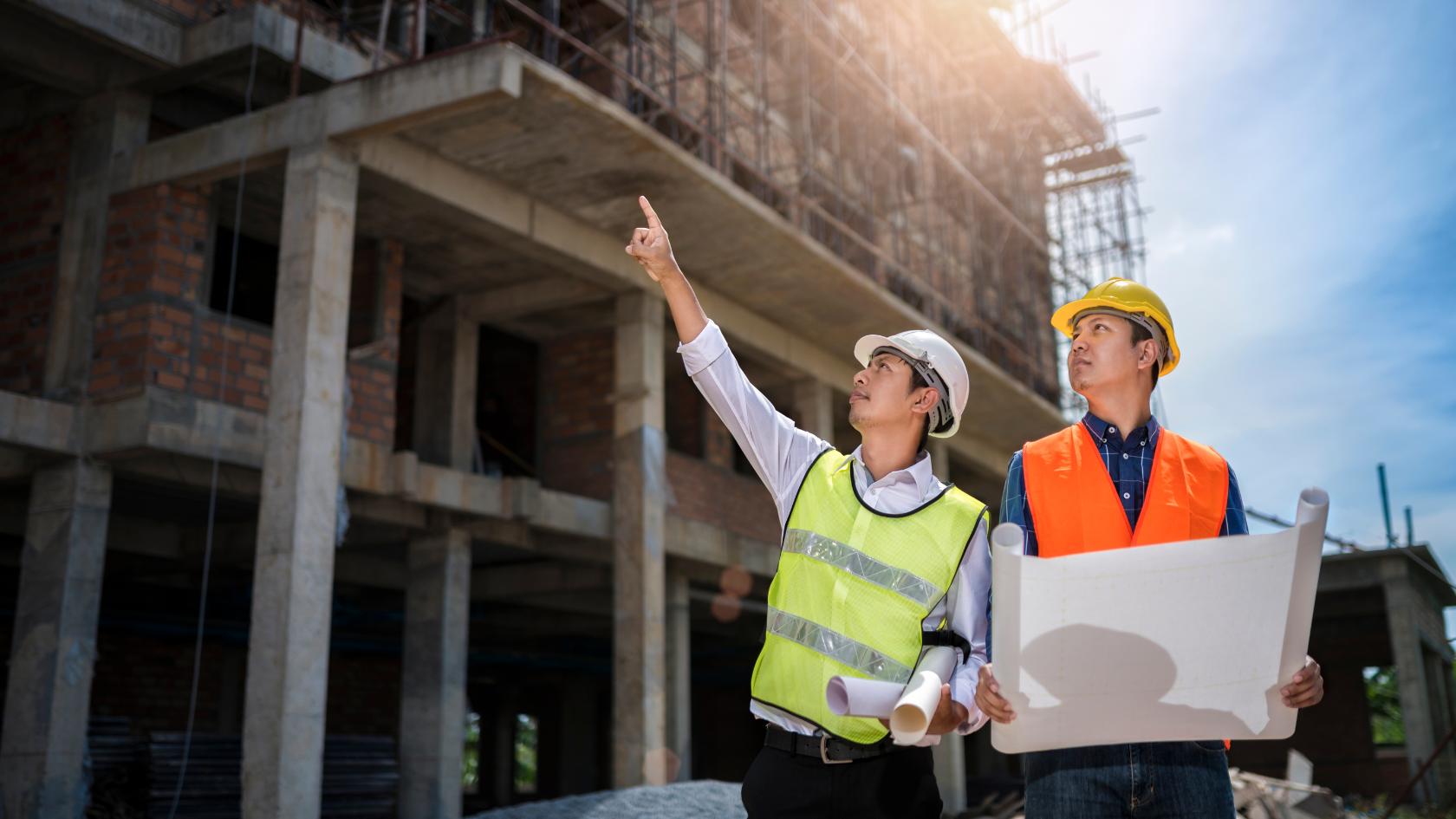 Construction professionals reviewing an active building site